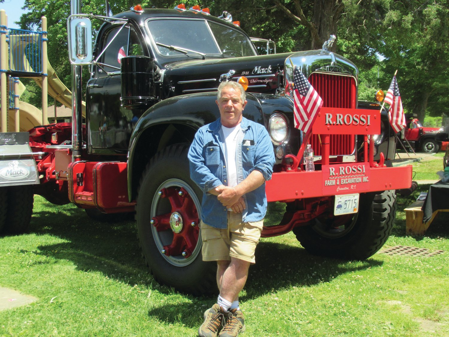 PRESIDENT’S PRIDE: Ron Rossi, president of the Ocean State Vintage Haulers, enjoys a lighter moment next to his huge truck that was among the 77 vintage vehicles that on display at Sunday’s 28th Annual Antique Truck Show inside Johnston War Memorial Park.